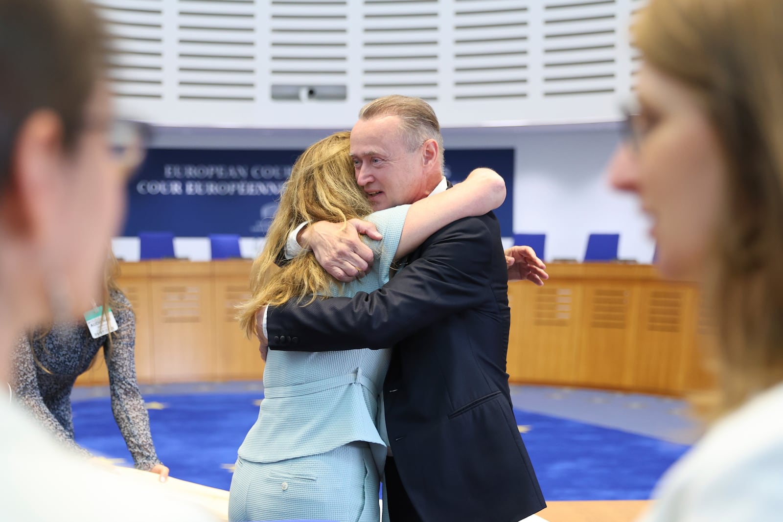 René Lefeber, right, deputy Legal Adviser of the Minister of Foreign Affairs of the Kingdom of the Netherlands, hugs agent to the European Court of Human Rights for Netherlands Babette Koopman after the European Court of Human Rights issued its judgment on Russian violations in Ukraine since 2014, including the downing of Malaysia Airlines flight MH17, Wednesday, July 9, 2025 in Strasbourg, eastern France. (AP Photo/Antonin Utz)