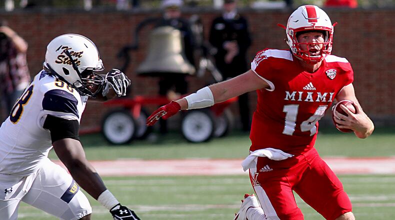 Contributed Photo by E.L. Hubbard Miami quarterback Gus Ragland gets away from Kent State defensive end Theo Eboigbe on his way to first down yardage during their game at Yager Stadium in Oxford Saturday, Oct. 15, 2016.