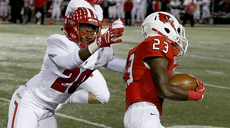 Fairfield’s Allen Caldwell (20) tries to make a tackle on Colerain’s J.J. Davis (23) during last Friday night’s game at Cardinal Stadium in Colerain Township. The host Cardinals won 55-27. CONTRIBUTED PHOTO BY E.L. HUBBARD