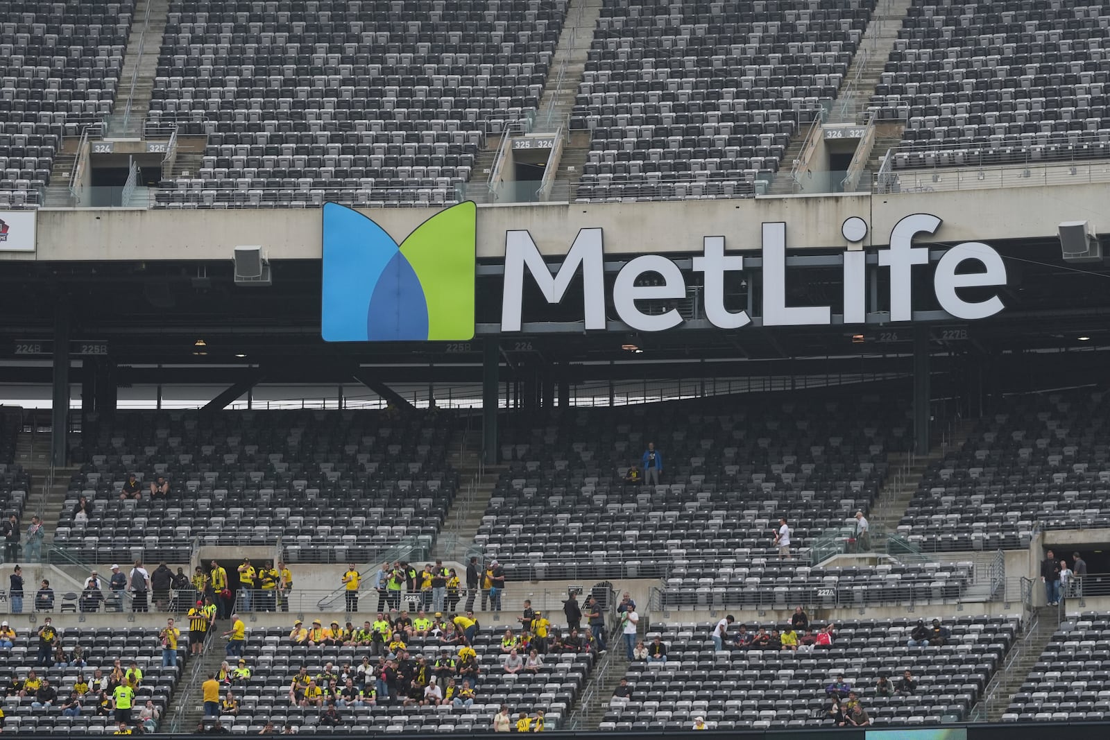 Fans take their seats for the Club World Cup group F soccer match between Fluminense and Borussia Dortmund in East Rutherford, N.J., Tuesday, June 17, 2025. (AP Photo/Seth Wenig)