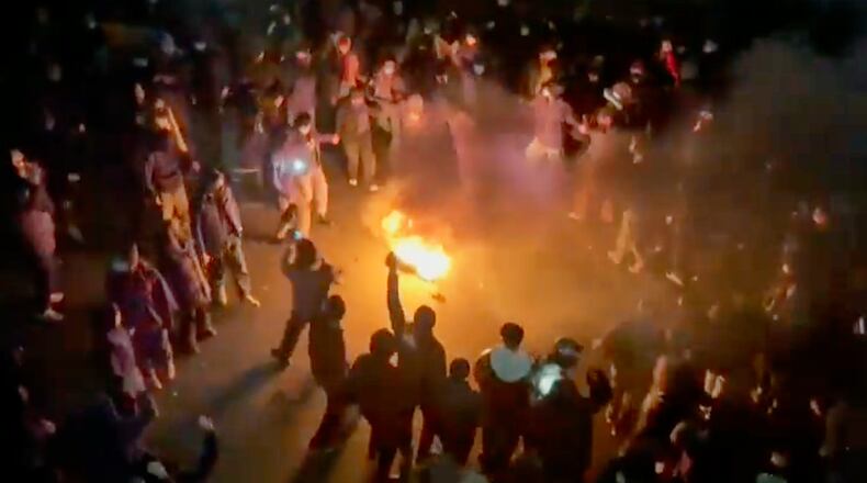 In this frame grab from footage circulating on social media shows protesters dancing and cheering around a bonfire as they take to the streets despite an intensifying crackdown as the Islamic Republic remains cut off from the rest of the world, in Tehran, Iran, Friday, Jan. 9, 2026.(UGC via AP)