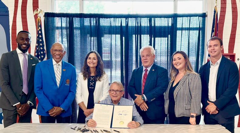 Ohio Gov. Mike DeWine signs an anti-hooning bill that was backed by Dayton Mayor Jeffrey Mims, Jr., along with Dayton-area state legislators Reps. Phil Plummer, R-Butler Twp., and Andrea White, R-Kettering. JULY 24, 2024.