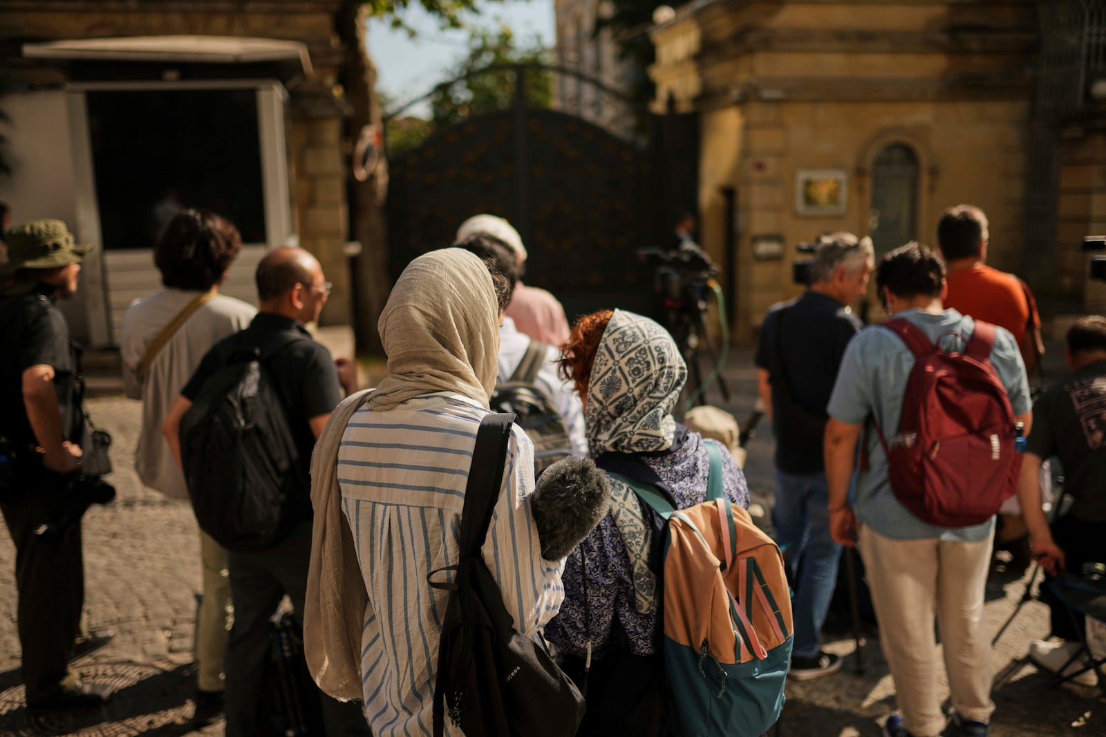 Journalists wait outside of the Iranian consulate, in Istanbul, Turkey, Friday, July 25, 2025, ahead of a meeting between European and Iranian diplomats for talks over Tehran's nuclear program. (AP Photo/Francisco Seco)