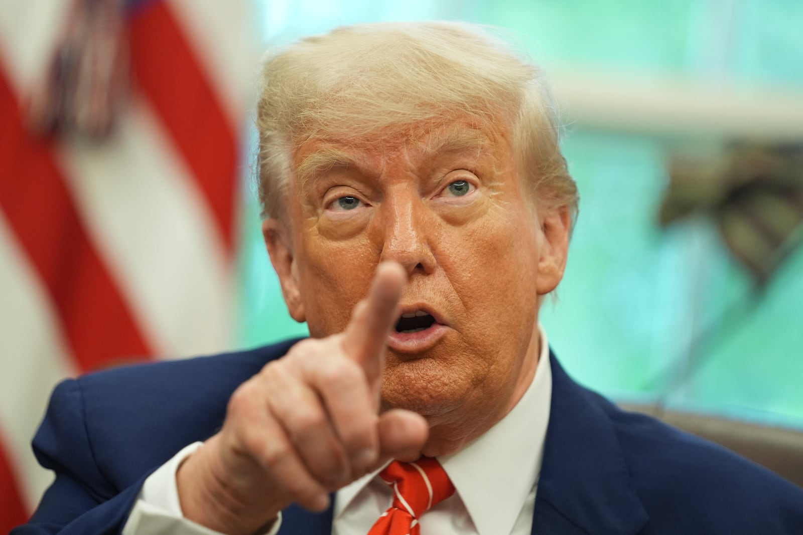 President Donald Trump gestures as he speaks with reporters after announcing a trade deal with United Kingdom in the Oval Office of the White House, Thursday, May 8, 2025, in Washington. (AP Photo/Evan Vucci)