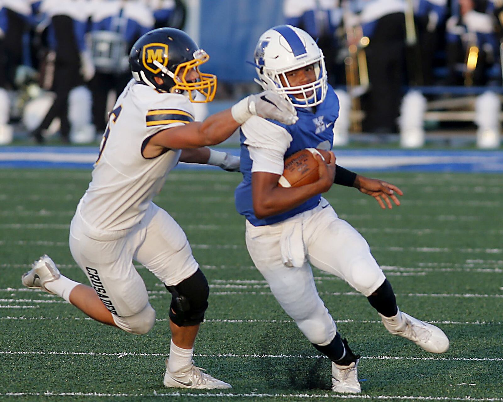Hamilton quarterback Khaliyal Sowell is tackled for a loss by Moeller’s Sam Wyche during their Skyline Chili Crosstown Showdown game at Virgil Schwarm Stadium in Hamilton on Saturday night. CONTRIBUTED PHOTO BY E.L. HUBBARD