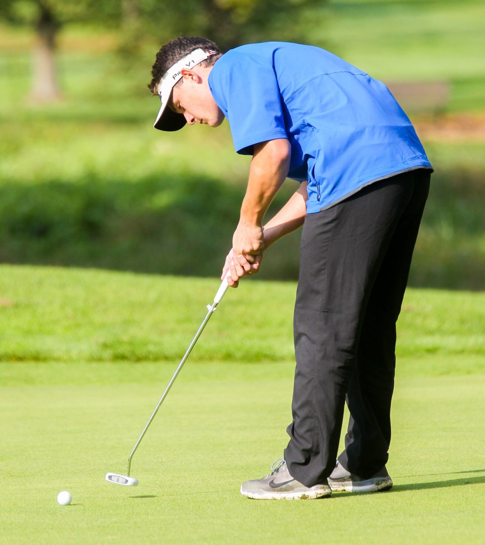 Trace Thomas of Hamilton putts during the Division I sectional boys golf tournament at Miami Whitewater Golf Course on Wednesday. GREG LYNCH/STAFF