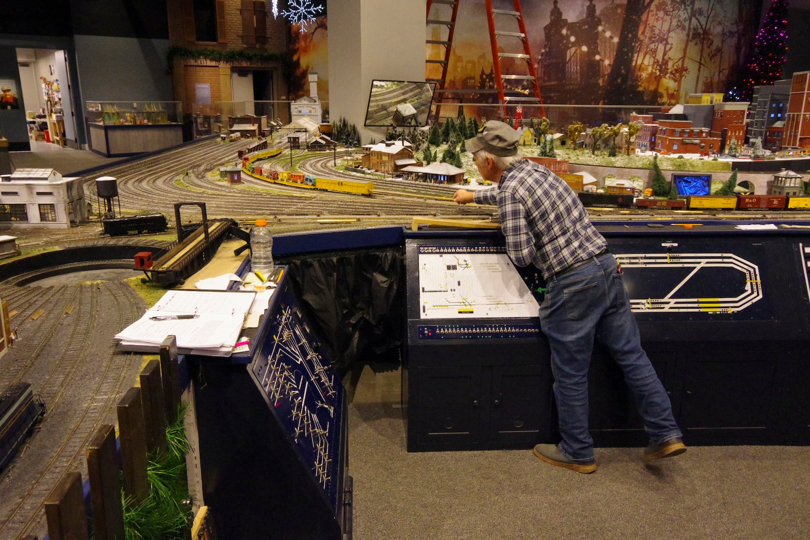 Trainmaster Tom Bredestege placing rolling stock on the B&O display in preparation for the Nov. 14 public opening of the layout. PHOTO BY JIM KRAUSE/CONTRIBUTED