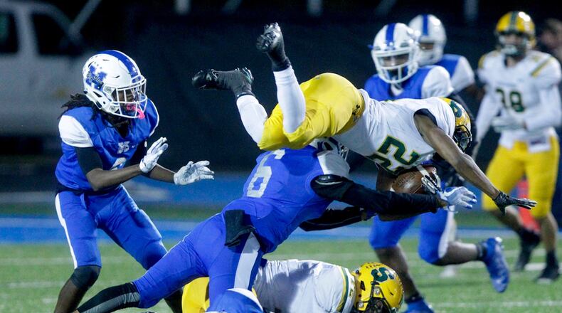 Hamilton’s Khaliyal Sowell delivers a big hit on Sycamore’s Jordan McConnel during Friday night’s game at Virgil Schwarm Stadium. Nick Graham/STAFF