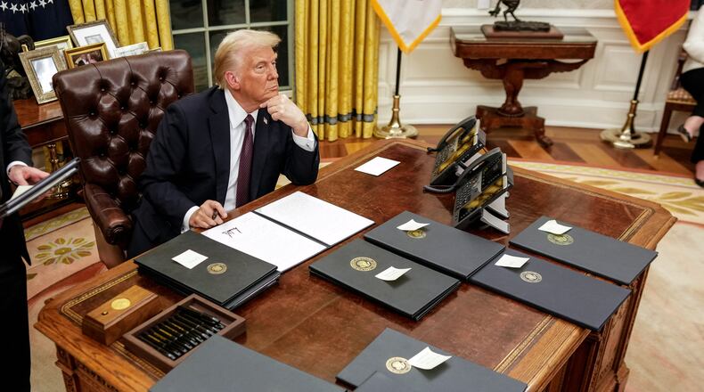 President Donald Trump pauses while signing  executive orders in the Oval Office of the White House in Washington on Monday, Jan. 20, 2025, following his inauguration as the 47th president. (Doug Mills/The New York Times)