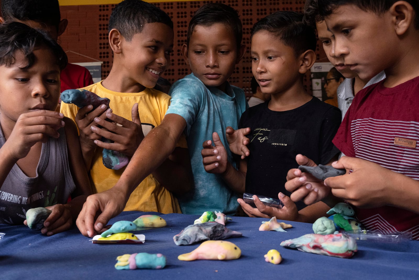 Children make manatee models out of Play-Doh during a trip to Emilio Goeldi Museum's scientific station in Para state, Brazil, Friday, March 21, 2025. (AP Photo/Jorge Saenz)