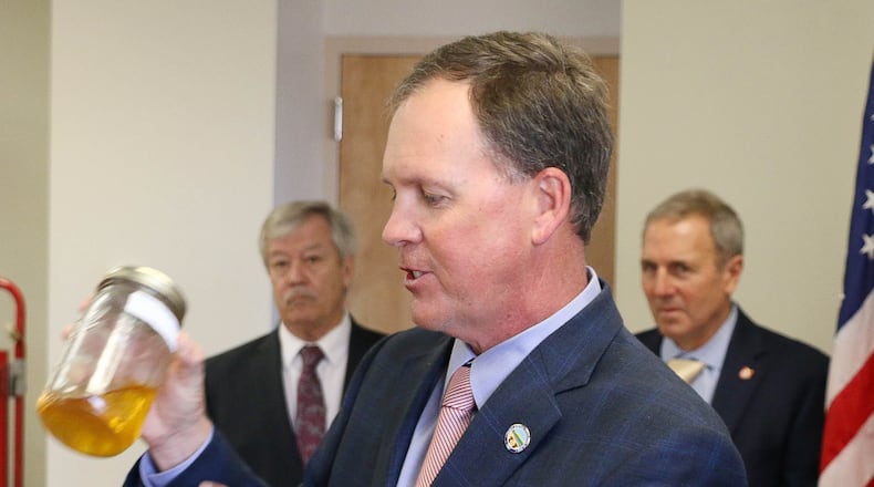 Butler County Auditor Roger Reynolds displays a sample of gas with a large amount of sediment collected from a station in the county. Reynolds, pictured during an online news conference Friday, is in support of proposed state legislation to allow county auditors to test the quality of fuel sold at stations. BUTLER COUNTY AUDITOR'S OFFICE