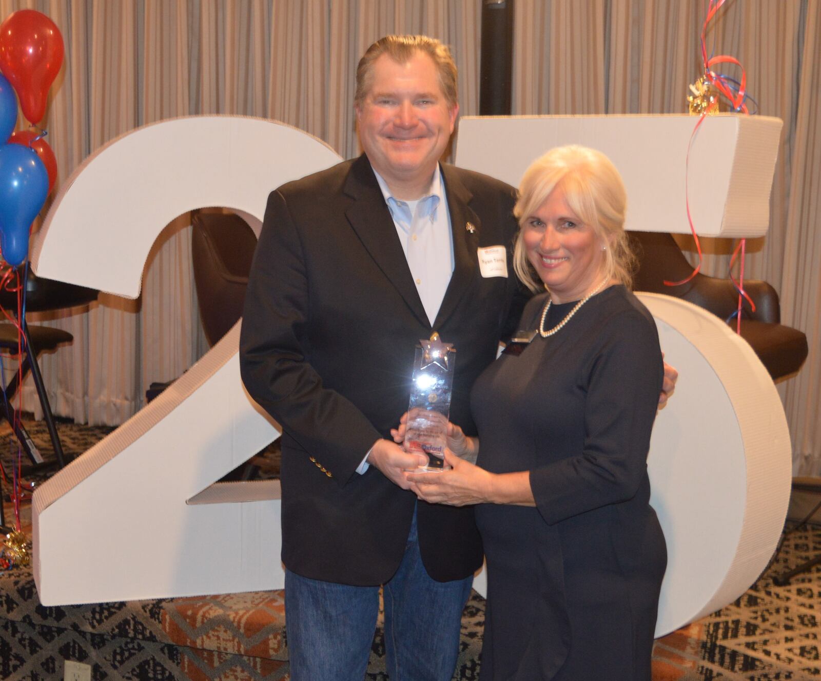 The Sigma Chi Foundation was recognized for its support of the Greater Oxford Area Community Foundation (GOACF) by providing office space and utilities for the past 25 years, saving money for the GOACF which was used in its support of community programs. Accepting the award was Ryan Temby, shown here with Executive Director Betsy Hope. CONTRIBUTED/BOB RATTERMAN