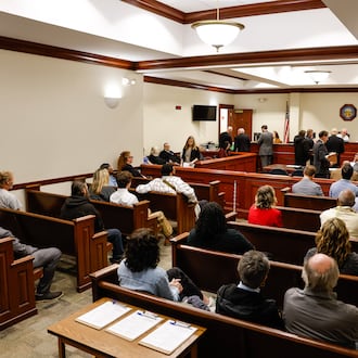 Butler County Area II Court Judge Kevin McDonough sits on the bench during the first docket day at the new location inside the old Hamilton municipal court at Butler County Government Services Center in Hamilton. Area I and Area II courts will work out of this courtroom. Judge McDonough is still waiting on a replacement robe after his was damaged in a fire at the historic Butler County Courthouse. NICK GRAHAM/STAFF