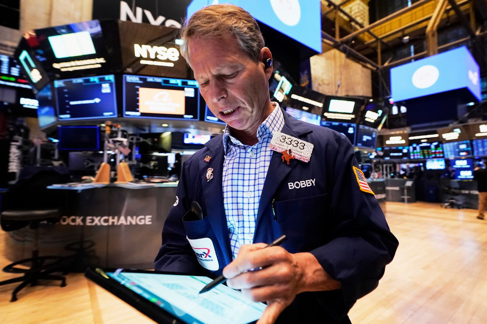 Trader Robert Charmak works on the floor of the New York Stock Exchange, Thursday, April 17, 2025. (AP Photo/Richard Drew)