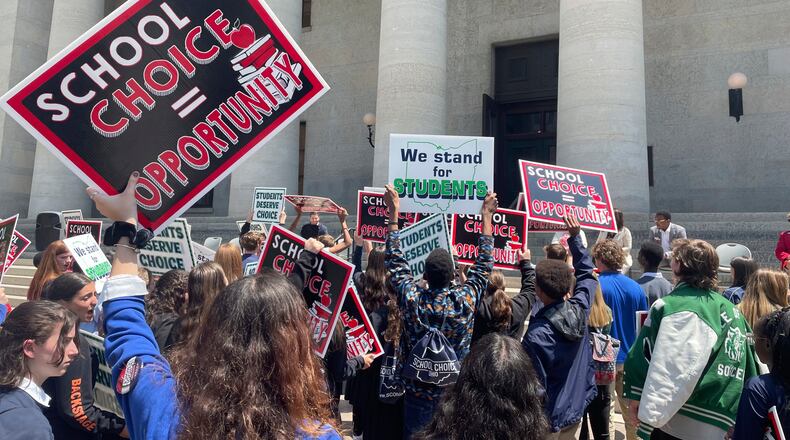 FILE - Students and parents rally at the Ohio Statehouse in support of possible changes that would increase eligibility for taxpayer-funded school vouchers to K-12 students statewide, May 17, 2023, in Columbus, Ohio. National Republicans are poised to support “universal school choice” as part of the policy platform they adopt at the 2024 Republican National Convention, which starts next week on Monday, July 15, 2024. (AP Photo/Samantha Hendrickson, File)