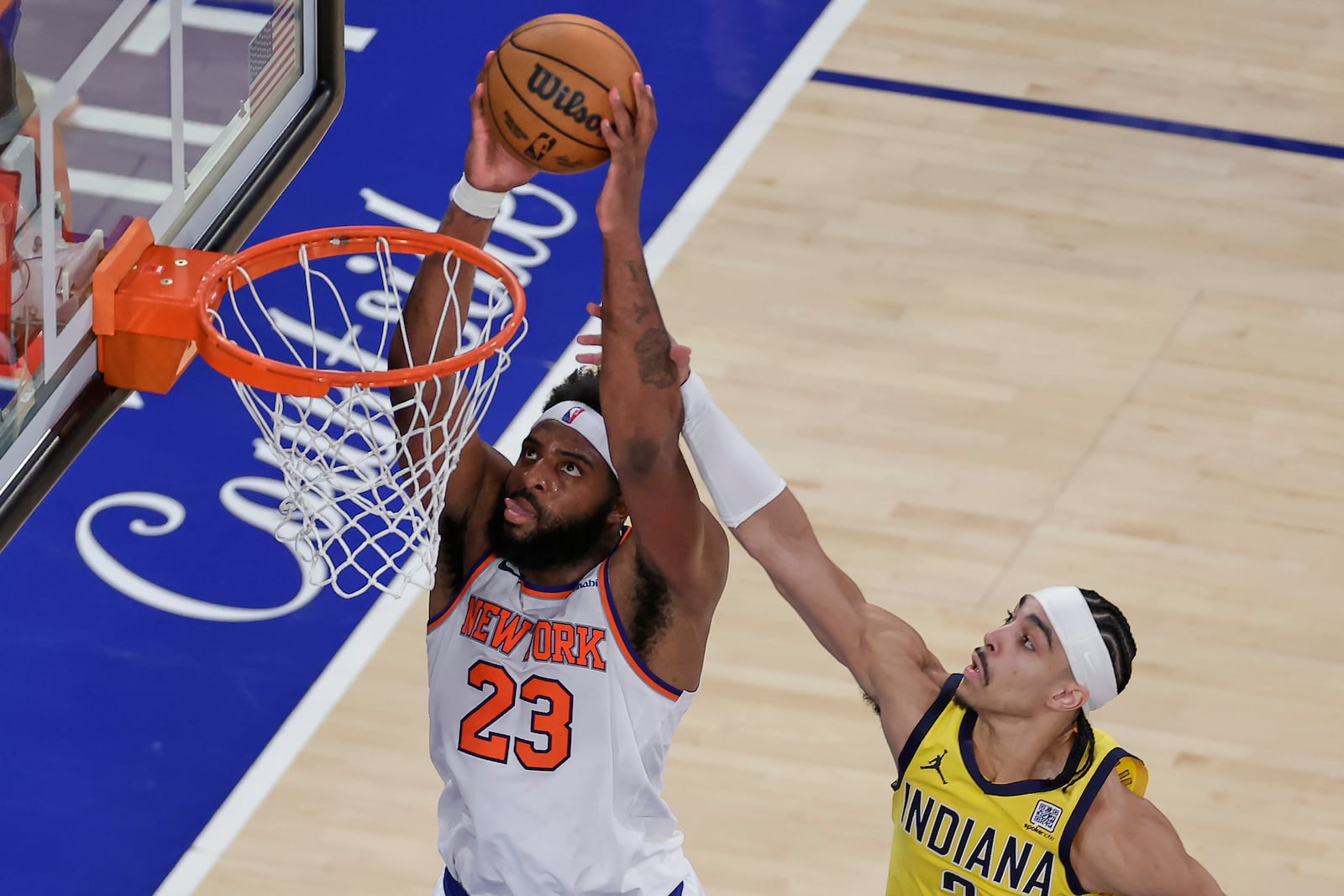 New York Knicks center Mitchell Robinson (23) goes up for a shot against Indiana Pacers guard Andrew Nembhard (2) during the fourth quarter of Game 2 of the NBA basketball Eastern Conference final, Friday, May 23, 2025, in New York. (AP Photo/Adam Hunger)
