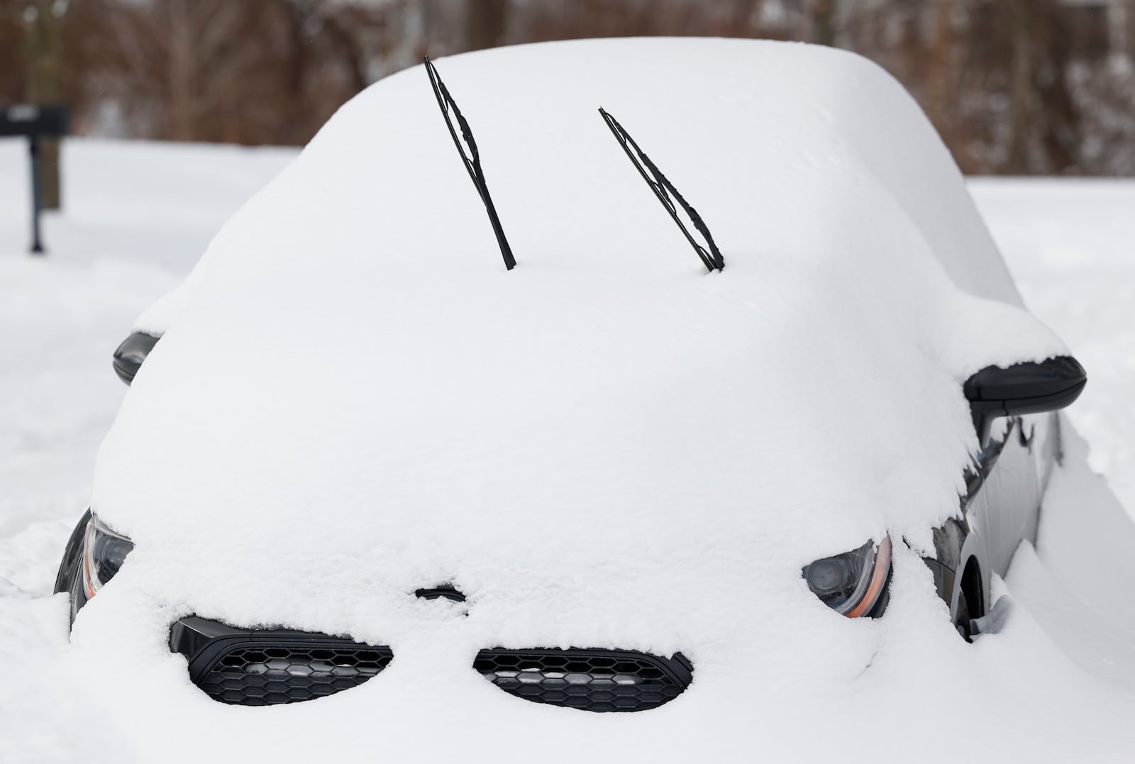 A vehicle is covered with snow on Monday, Jan. 26, 2026, in Columbus. Certain areas across central and southern Ohio got around a foot of snow. JOSEPH COOKE/STAFF