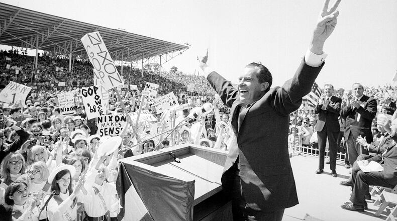 FILE - In this Sept. 19, 1968, file photo, then-presidential candidate Richard Nixon flashes the victory sign as he acknowledges cheers from the crowd, at the fairgrounds of Springfield, Mo. Theres little doubt Nixon was up to dirty tricks before his presidency ever began. Documents released by the Nixon Presidential Library add weight to existing evidence that his 1968 presidential campaign tried to sabotage Vietnam peace talks before the U.S. election. (AP Photo/File)