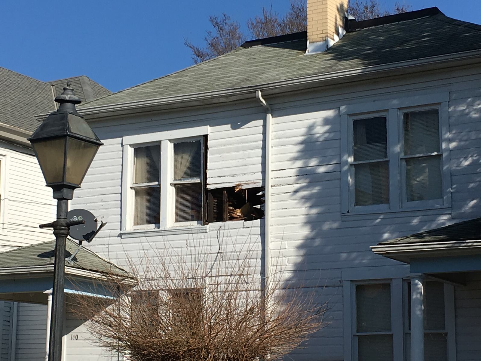 A compressed air cylinder shot over homes,  hit the pavement and ricocheted into an upper story bedroom of a Seventh Street house on Sunday afternoon, Feb. 19, 2017, in Hamilton. RICK McCRABB / STAFF