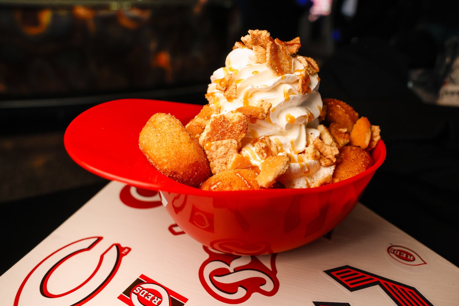 Double Play Donut Parfait is one of 15 new menu items at Great American Ball Park for Cincinnati Reds' 2026 season. It features 12 cinnamon sugar donuts with house-made banana pudding, vanilla wafers, Cinnamon Toast Crunch, whipped cream and caramel sauce. NICK GRAHAM/STAFF