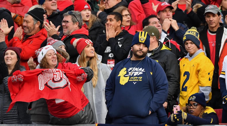 COLUMBUS, OH - NOVEMBER 24: Ohio State fans celebrate in the fourth quarter after the Buckeyes added another touchdown as Michigan Wolverines fans watch at Ohio Stadium on November 24, 2018 in Columbus, Ohio. Ohio State defeated Michigan 62-39. (Photo by Jamie Sabau/Getty Images)