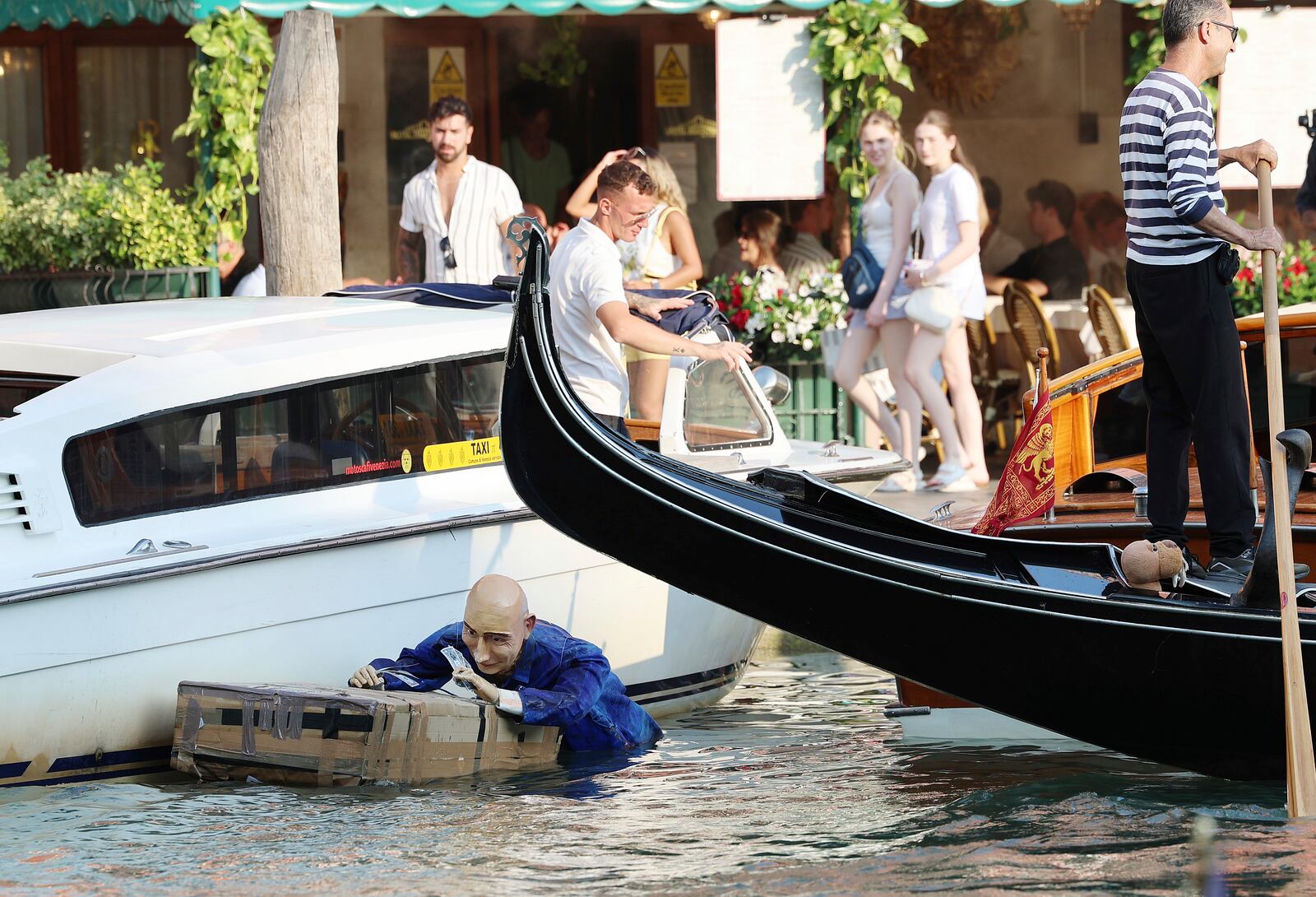 A mannequin resembling Jeff Bezos floats in a canal in Venice, Italy, on Tuesday, June 24, 2025, ahead of festivities in the lagoon city reportedly linked to a wedding celebration for Jeff Bezos and Lauren Sánchez. (Click News via AP)