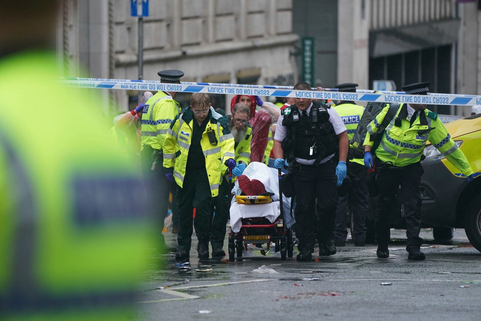 Police and emergency personnel deal with an incident near the Liver Building during the Premier League winners parade, in Liverpool, England, Monday May 26, 2025. (Owen Humphreys/PA via AP)