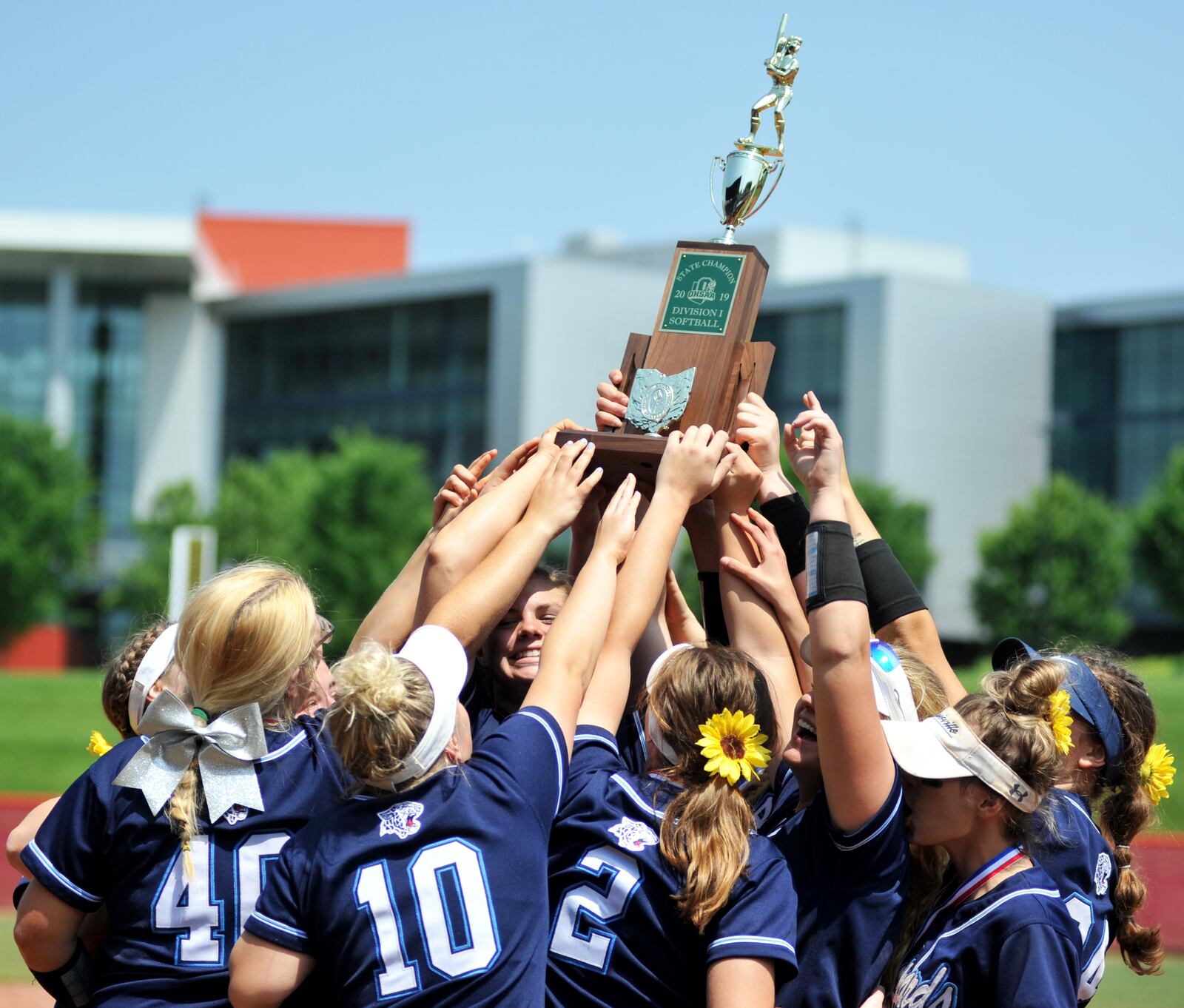 Louisville’s players celebrate their Division I state softball championship Sunday after rallying for a 14-10, 10-inning victory over Lakota East at Firestone Stadium in Akron. RICK CASSANO/STAFF