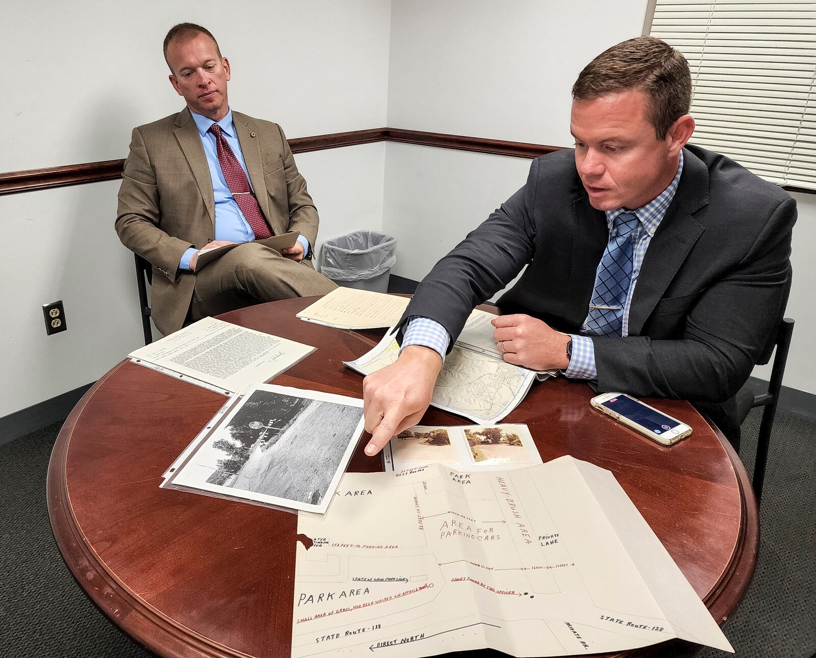 Lieutenant Ed Tanner, left, and detective Dan Turner show some of the evidence from a cold case over 50 years old. Georg Ann Reiter was shot in the back and killed at a park along OH-128 in 1970. NICK GRAHAM/STAFF
