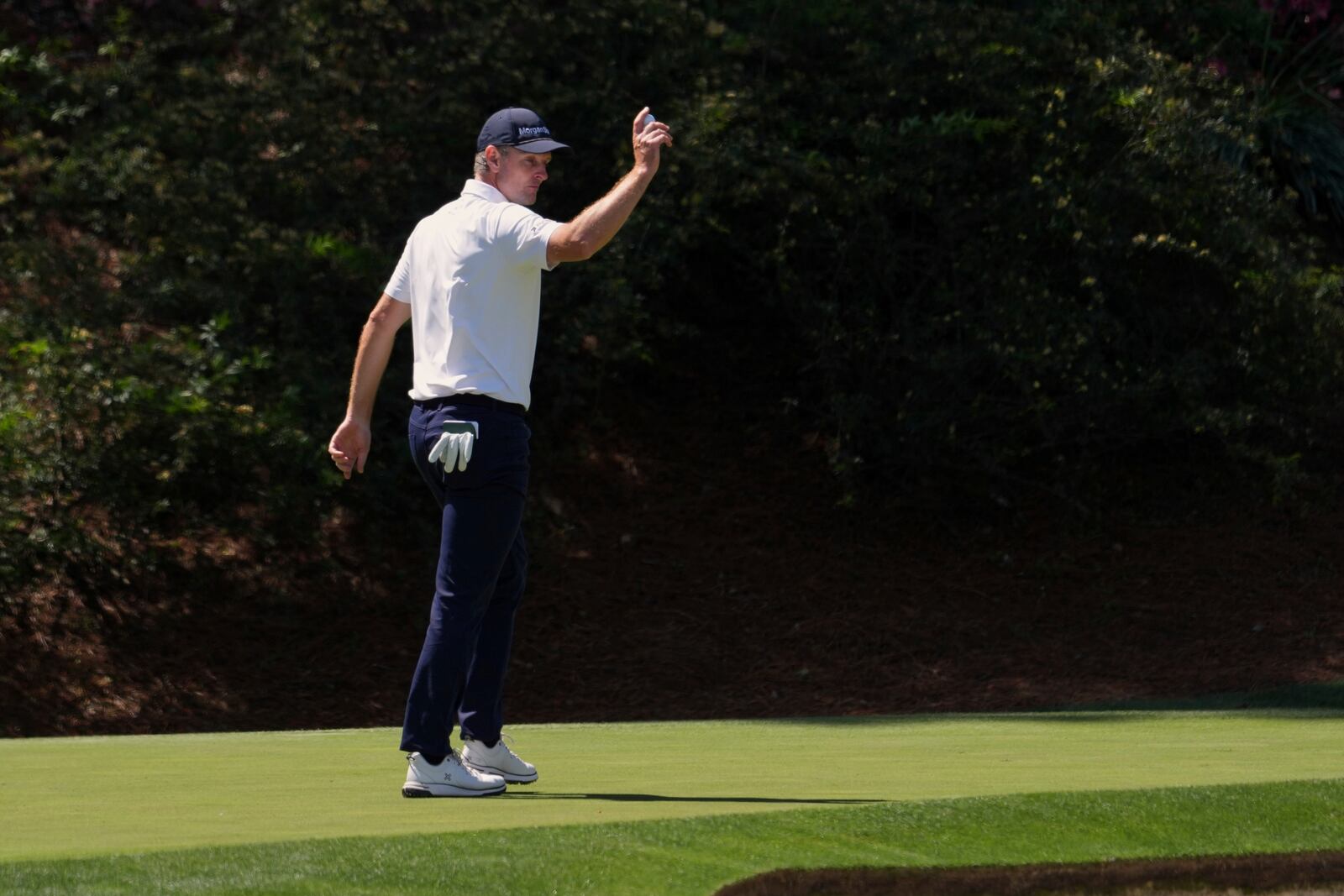 Justin Rose waves after making a putt on the 12th hole during the second round at the Masters golf tournament, Friday, April 11, 2025, in Augusta, Ga. (AP Photo/Matt Slocum)