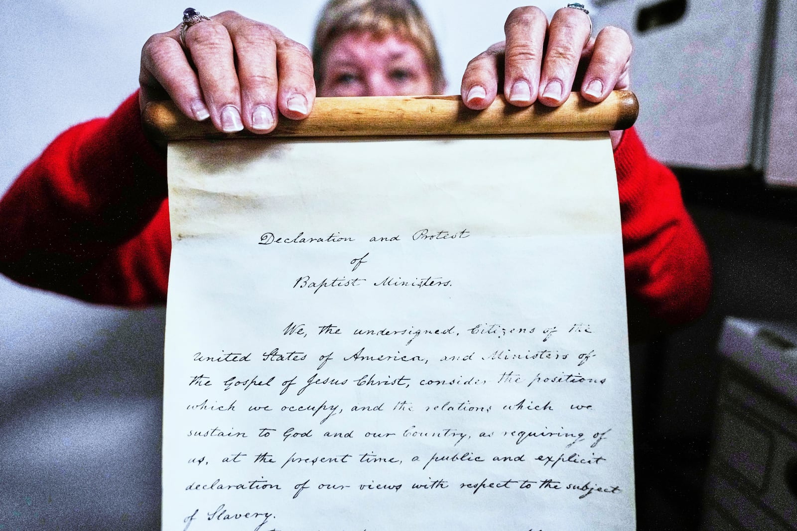 Historian Jennifer Cromack holds a recently found, 178-year-old anti-slavery scroll at Grotonwood, the home mission of The American Baptist Churches of Massachusetts, Thursday, June 26, 2025, in Groton, Mass. (AP Photo/Charles Krupa)