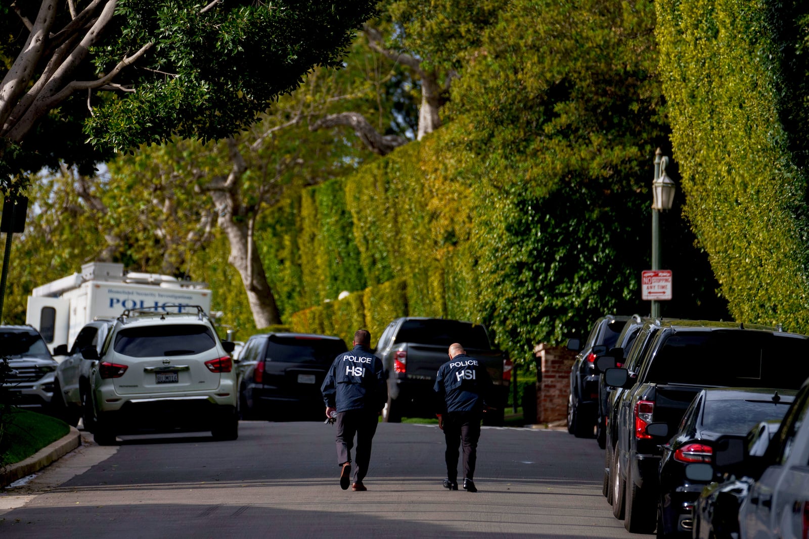FILE - Law enforcement personnel walk on a street near after federal law enforcement executed a raid at a property belonging to Sean "Diddy" Combs on March 25, 2024, in Los Angeles. (AP Photo/Eric Thayer, File)