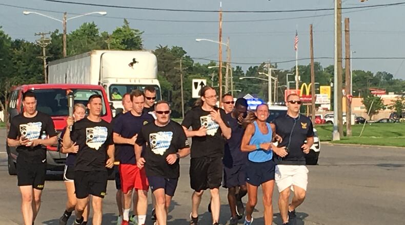 Middletown police officer Kim Robinson, in blue shirt, participated in her last Law Enforcement Torch Run this morning in Middletown. Robinson is retiring next year. RICK McCRABB/STAFF
