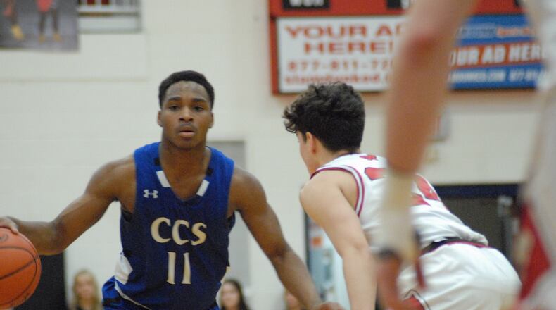 Cincinnati Christian's Caleb Brown is guarded by Madison's Kyle Rubio on Thursday night. Brown scored a game-high 27 points. Chris Vogt/CONTRIBUTED