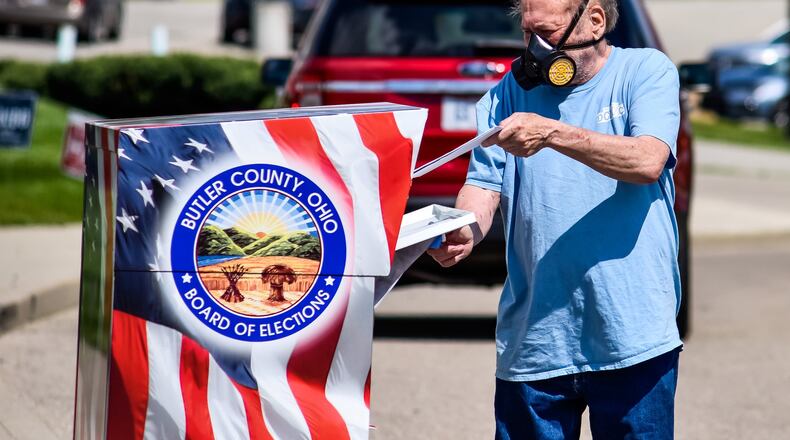 Larry Wallace turns in his ballot at the Butler County Board of Elections on Princeton Road in Hamilton on election day Tuesday, April 28 after it had been postponed due to coronavirus pandemic. NICK GRAHAM / STAFF