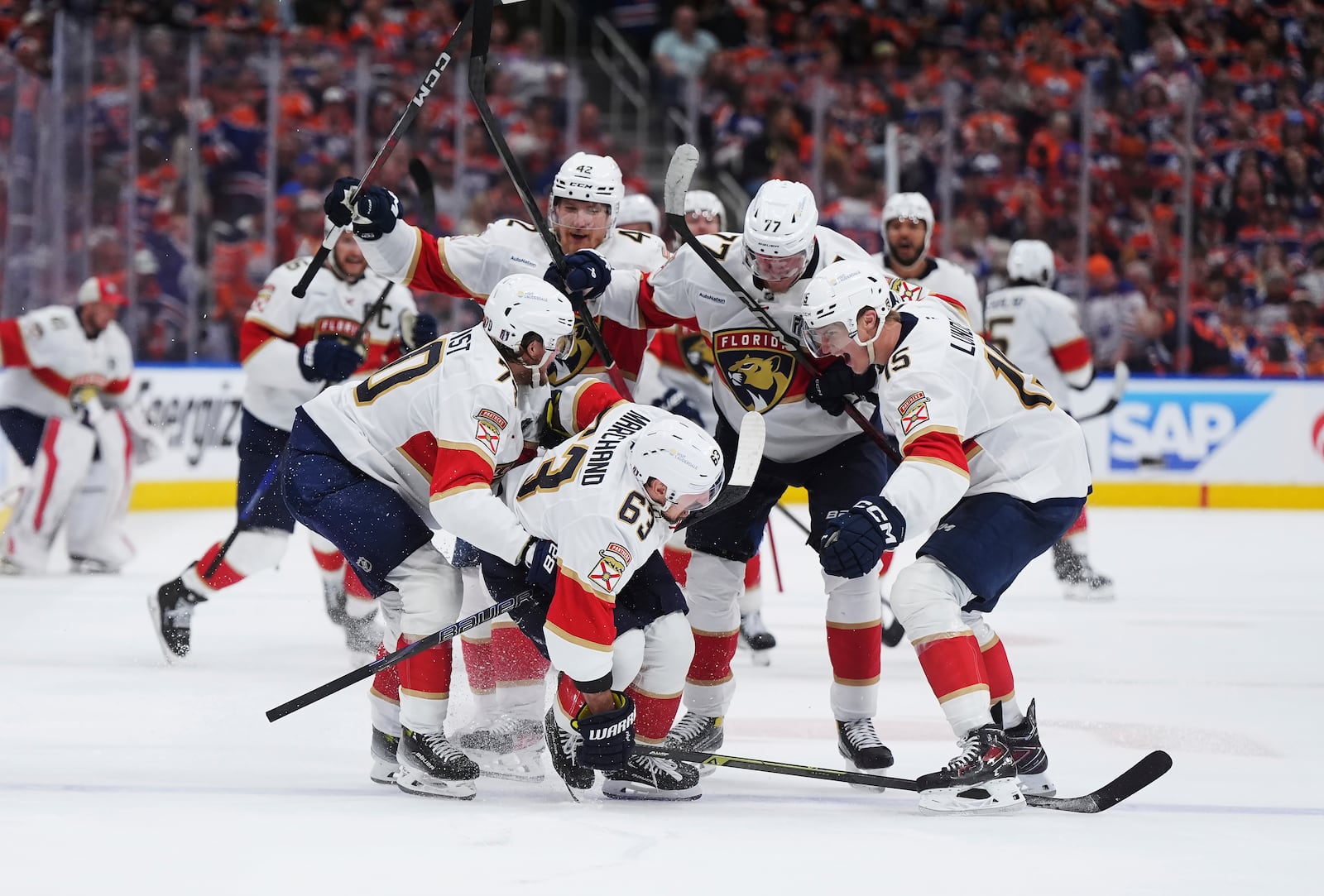 Florida Panthers' Brad Marchand (63) celebrates his game-winning goal against the Edmonton Oilers with teammates during the second overtime period in Game 2 of the NHL Stanley Cup final in Edmonton, on Friday, June 6, 2025. (Darryl Dyck/The Canadian Press via AP)