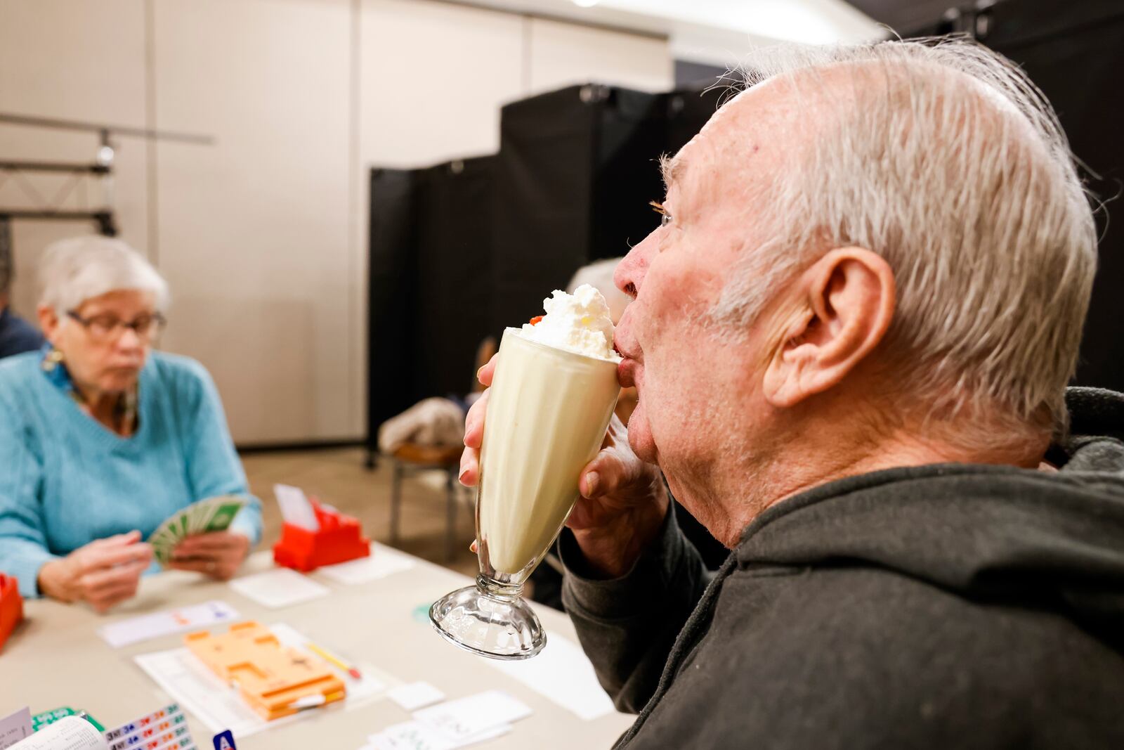 Perry Seal sips a milkshake while he plays bridge at Central Connections after their ribbon cutting and tour of the renovated facility Tuesday, Nov. 1, 2022 on Central Ave. in Middletown. The $900,000 in renovations have turned the senior center into a recreation center with full restaurant and bar, bridal suite and rooms to host weddings, fitness room and more. NICK GRAHAM/STAFF