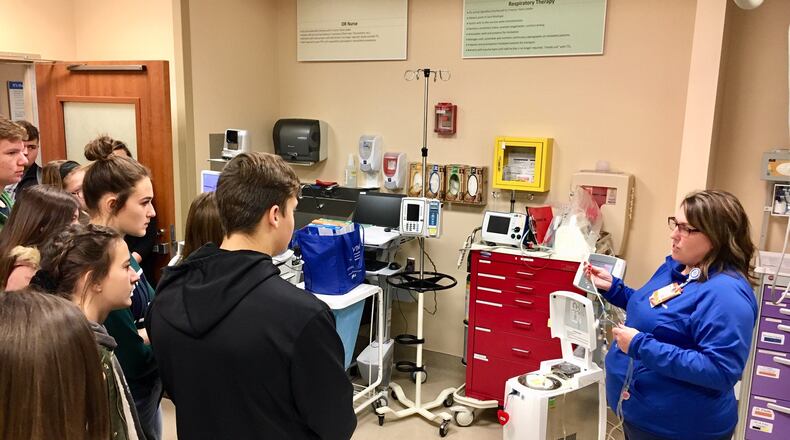 Students from Middletown and Madison high schools toured the Atrium Medical Center on Friday as part of the health provider and local chamber of commerce’s efforts to expose more youth to career options. Wendy Mitchell, nurse manager in Atrium’s emergency room, demonstrates some of the life-saving equipment used in their work.