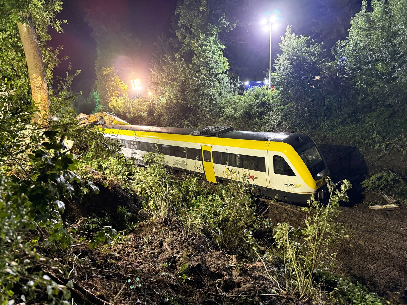 A carriage of the derailed regional passenger train stands on a section of track near Riedlingen, Germany, Sunday, July 27, 2025. (Nico Pointner/dpa via AP)