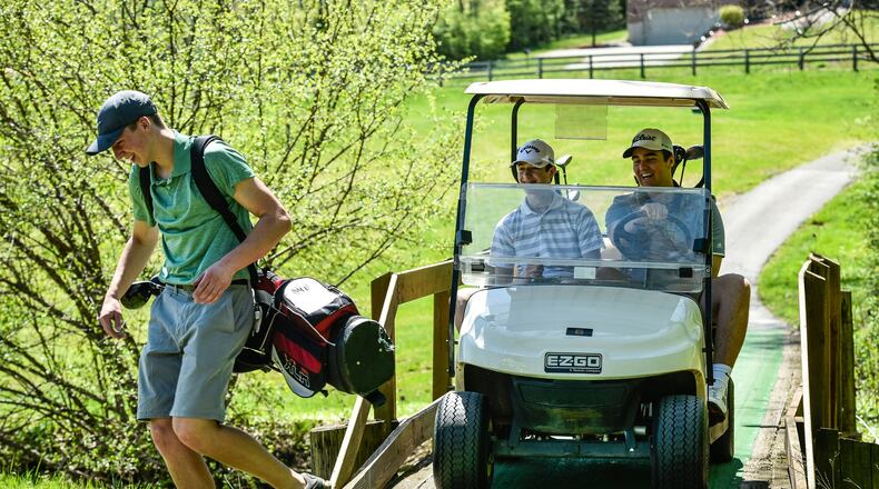 Kenny Pendergest, 17, makes his way across a bridge trailed by Nathan Schuster, 16, right, and Sean Pendergest, 15, during a round of golf May 1 at Potter’s Park Golf Course in Hamilton. NICK GRAHAM/STAFF