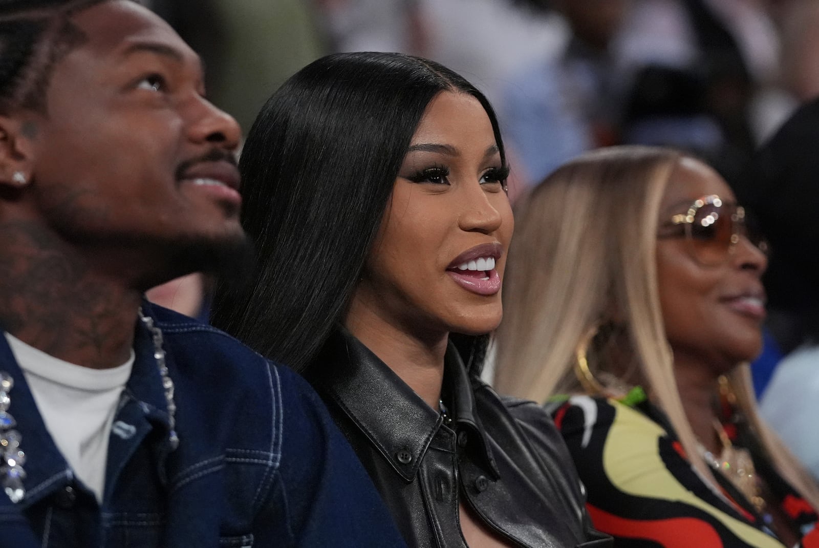 FILE - Cardi B, center, Stefon Diggs, left, and Mary J Blige, right, watch during the second half of Game 4 in the Eastern Conference semifinals of the NBA basketball playoffs between the New York Knicks and the Boston Celtics Monday, May 12, 2025, in New York. (AP Photo/Frank Franklin II, File)