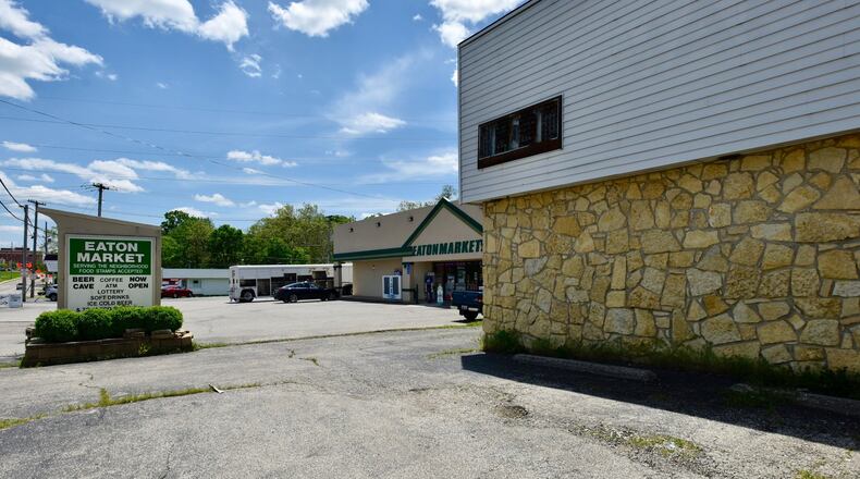 The company that owns Eaton Market plans to tear down the building in the foreground and replace it with four gasoline pumps and a canopy with a Shell sign on it. Some are concerned the change would worsen issues with vehicle and pedestrian traffic in the area. NICK GRAHAM/STAFF