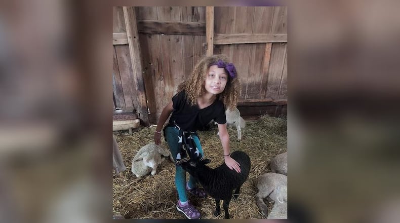 Pamela’s daughter Jasmine makes a furry friend during a summer visit to The Learning Tree Farm. PAMELA CHANDLER/CONTRIBUTED