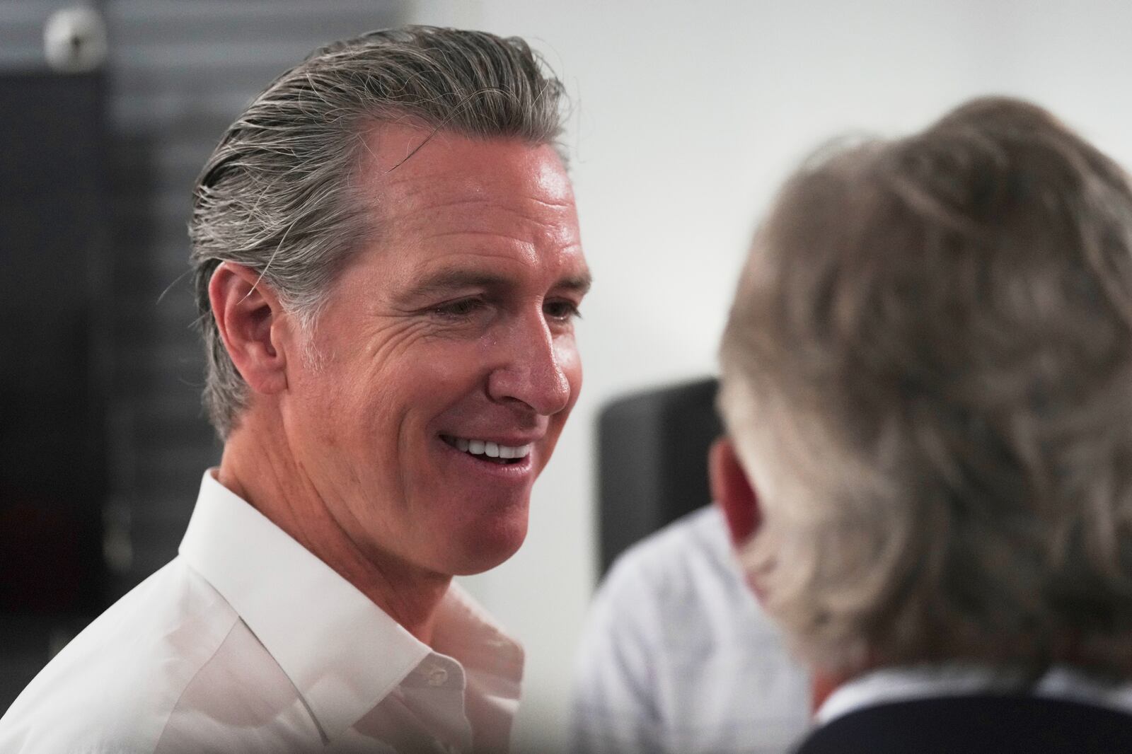 Gov. Gavin Newsom, D-Calif., greets people in a coffee shop during a two-day swing through South Carolina on Tuesday, July 8, 2025, in Florence, S.C. (AP Photo/Meg Kinnard)
