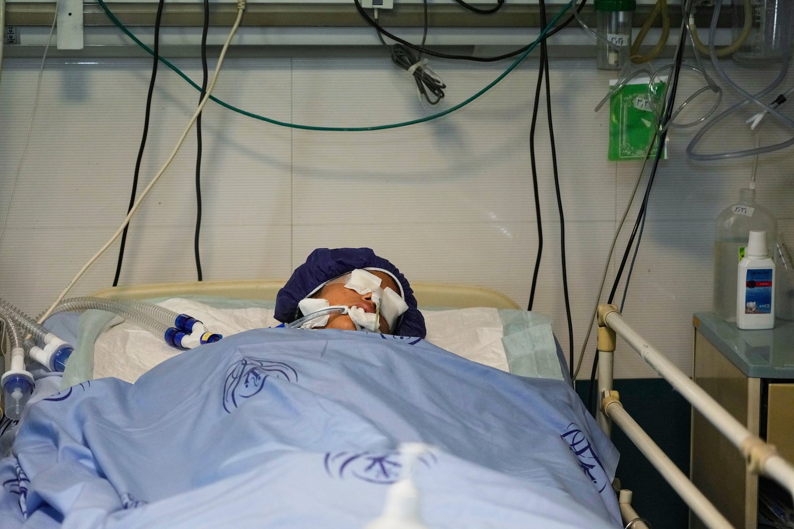 Parnia Rahmanian, 13, lies unconscious in a hospital bed following Israeli strike that targeted her neighborhood, in Tehran, Iran, Saturday, June 21, 2025. (AP Photo/Vahid Salemi)