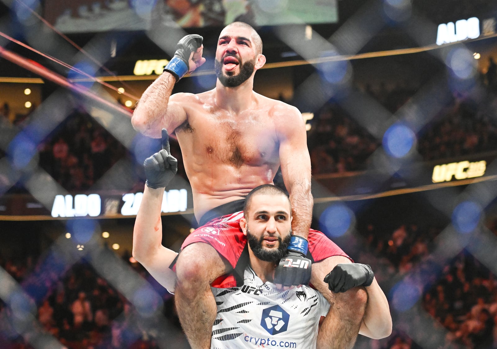 Aiemann Zahabi, top, reacts following his win over Jose Aldo during their UFC 315 mixed martial arts featherweight bout in Montreal, Saturday, May 10, 2025. (Graham Hughes/The Canadian Press via AP)