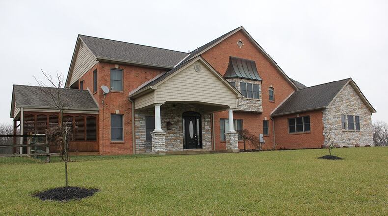 This 4-bedroom, custom-built home in Morgan Twp. is set on 130 acres and boasts more than 7,500 sq. ft. of living space. The property includes a pool, lake, barn and 20 tillable acres. CONTRIBUTED PHOTO BY GINNY MCCABE