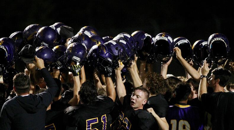 Mechanicsburg huddles after a victory against Kenton Ridge on Friday, Aug. 30, 2019, at Mechanicsburg. David Jablonski/Staff