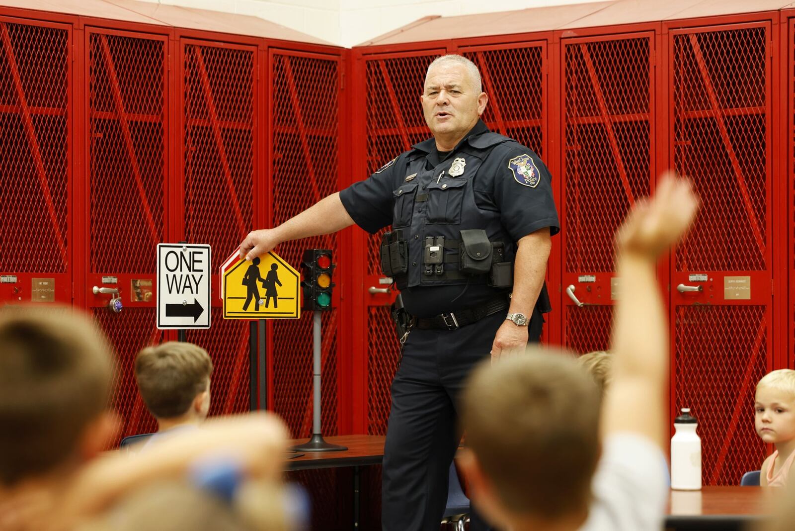 West Chester Police offi er Gary Gabbard quizzes the kids on crosswalk safety. Lakota schools, West Chester Police Department, Butler County Sheriff's Office and other have partnered for Lakota Safety Village to teach young children going into kindergarten school etiquette, bus and car safety, fire safety and more at Lakota Freshman School in West Chester Township. NICK GRAHAM/STAFF