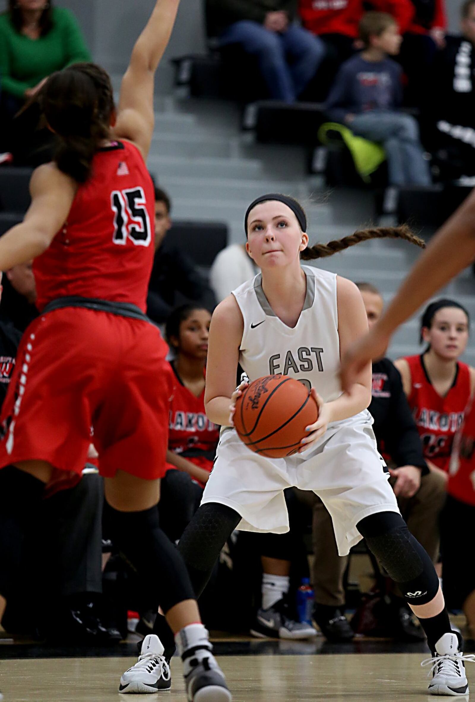 Lakota East guard Holly Thompson sets to shoot as Lakota West guard Sarah Jones pressures her during their game in Liberty Township on Wednesday night. CONTRIBUTED PHOTO BY E.L. HUBBARD